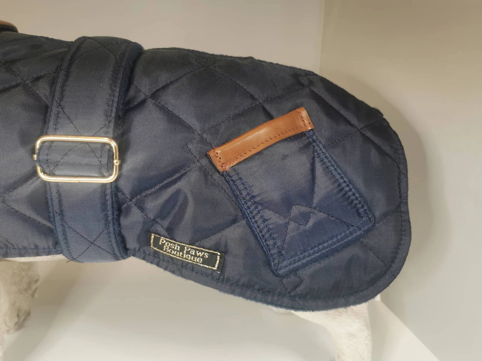 Navy blue quilted dog coat with genuine leather trims